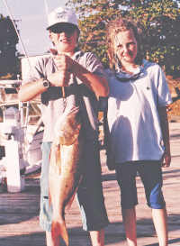 mutton snapper held by Mitchell family children