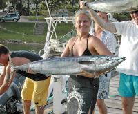 wahoo held horizontally by lady angler