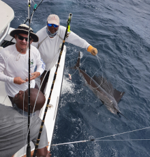 Dan and George with his sailfish at the back of the boat