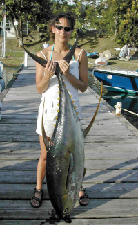 Kelly holds her yellowfin tuna on the dock at GYC