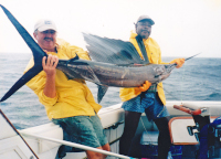 Badger's sailfish in the boat held by Gary & Leslie in raincoats