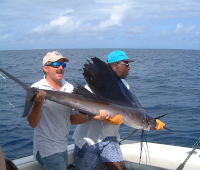 sailfish held by Gary & Leslie in the boat before release