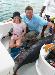 Ray & daughter with the blue marlin in the boat after it died