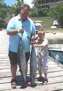 father and son bonding catching wahoo on True Blue Sportfishing Grenada
